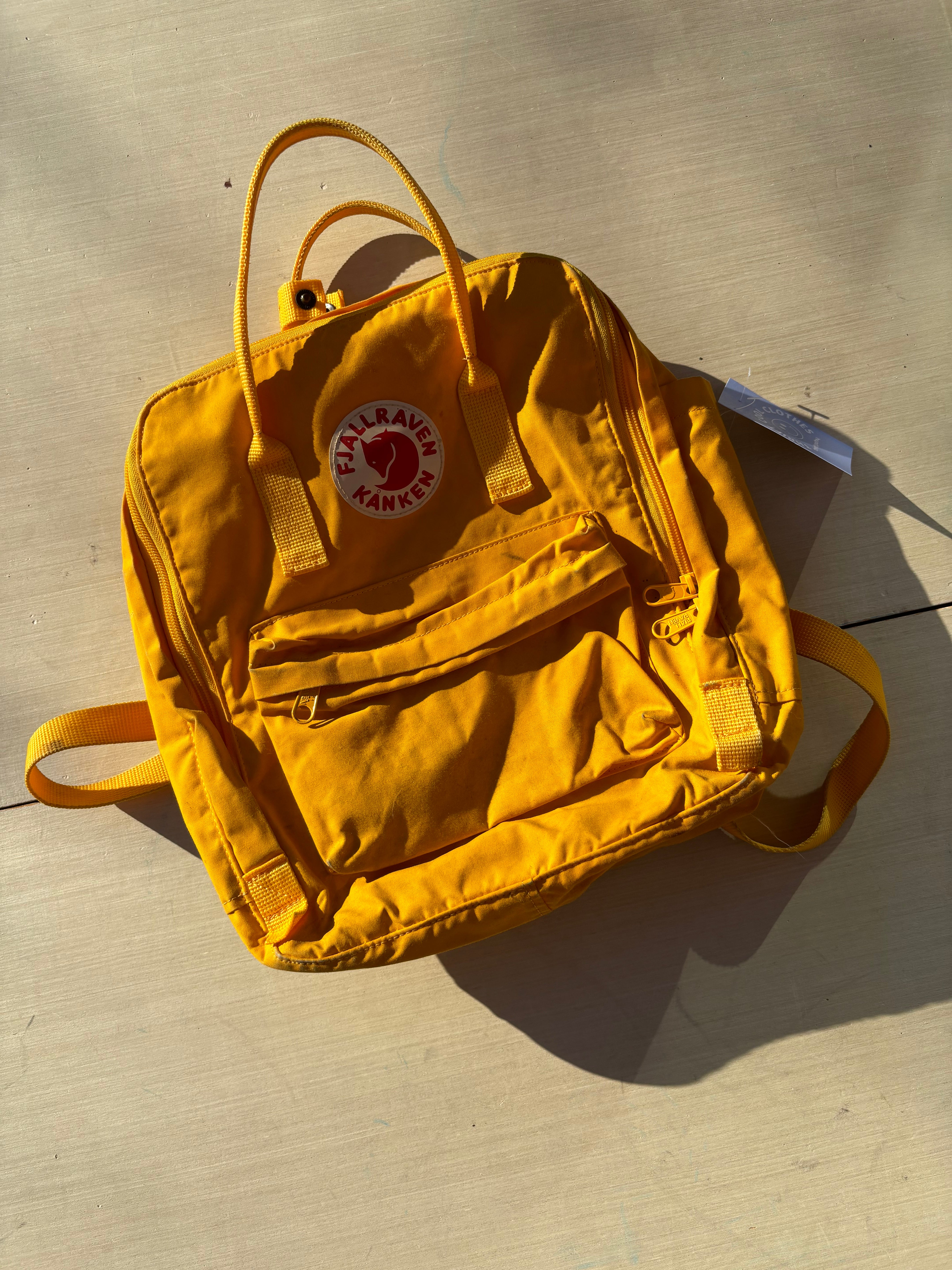 yellow Fjallraven kanken backpack