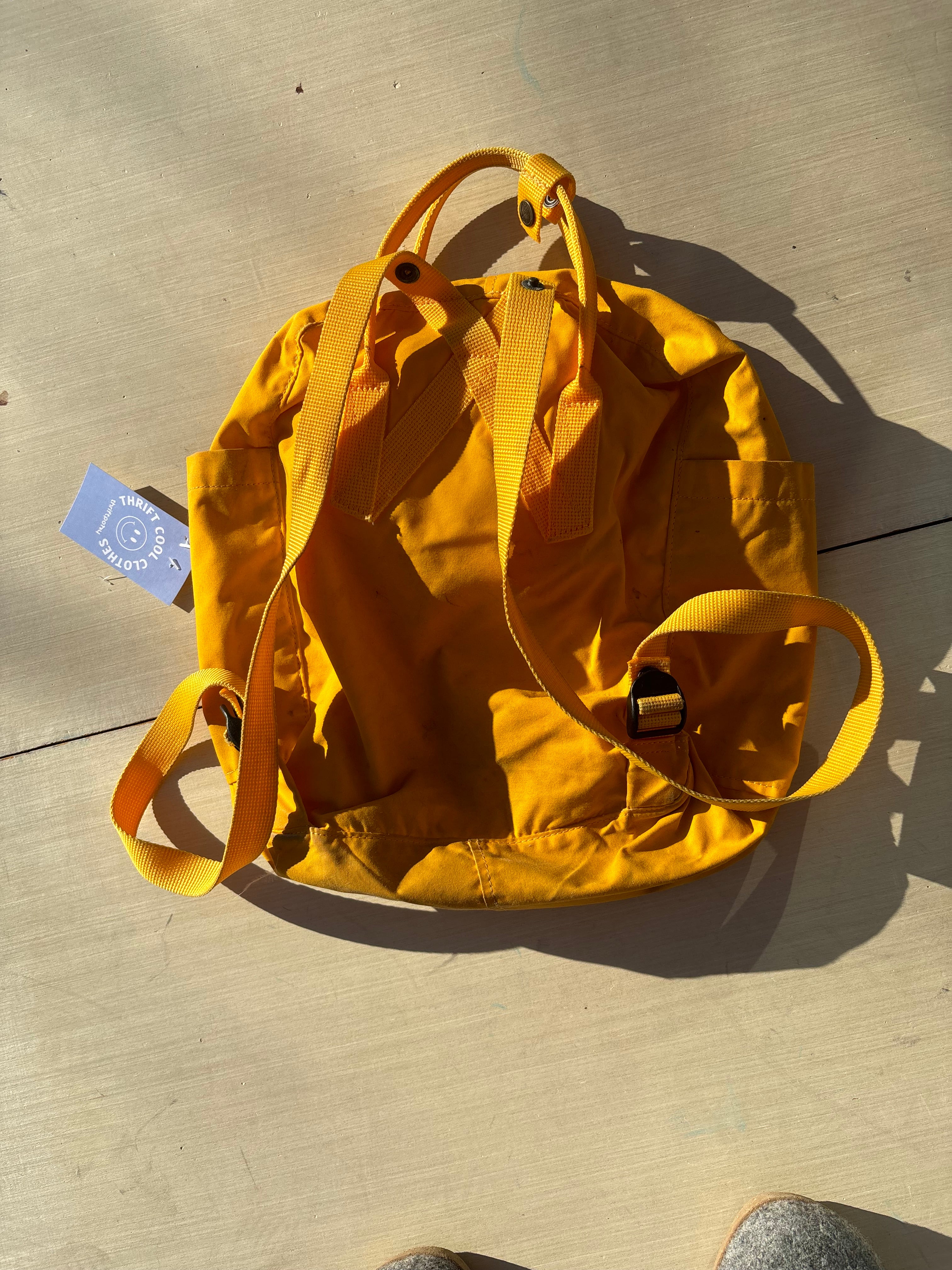 yellow Fjallraven kanken backpack